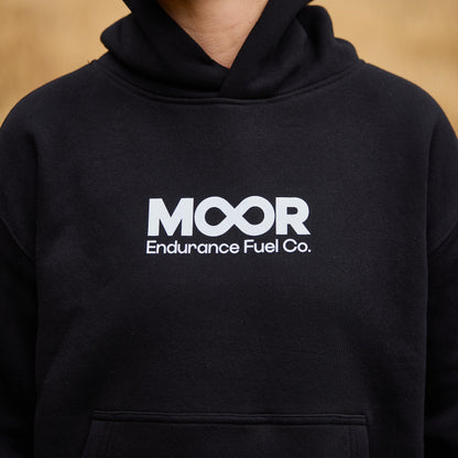 Person wearing a black hoodie with 'MOOR Endurance Fuel Co.' logo.